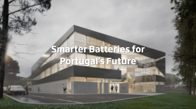 Modern glass-fronted building at dusk with the text “Smarter Batteries for Portugal’s Future.”